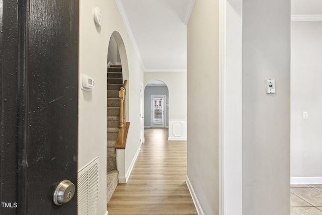 212 Cross Keys Ct, Cary, NC 27511 - hall with arched walkways, crown molding, light wood-style floors, and stairway