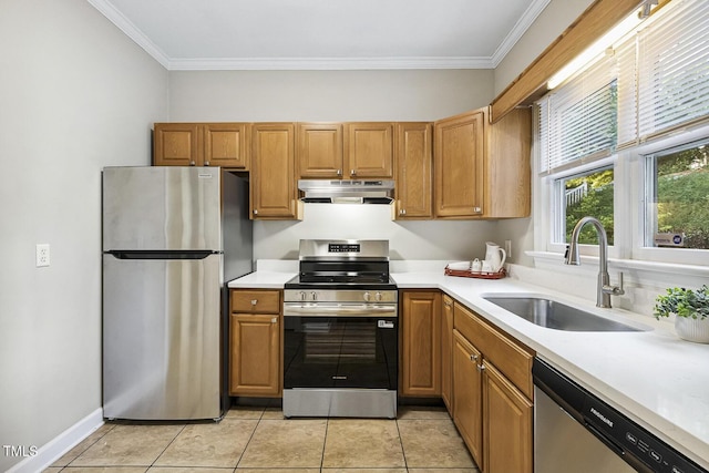 212 Cross Keys Ct, Cary, NC 27511 - kitchen with stainless steel appliances, under cabinet range hood, light countertops, crown molding, and light tile patterned floors