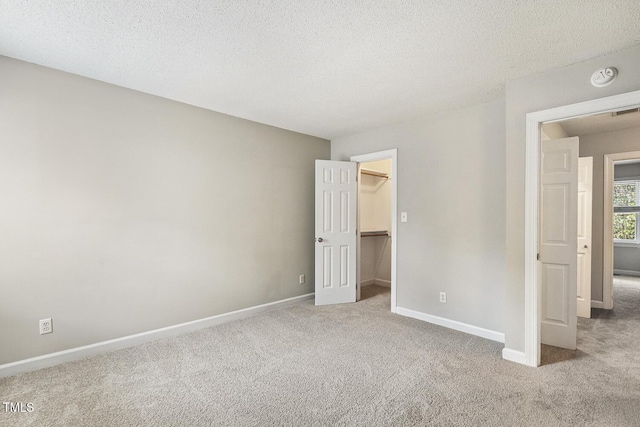 212 Cross Keys Ct, Cary, NC 27511 - unfurnished bedroom featuring carpet floors, a walk in closet, a textured ceiling, and a closet