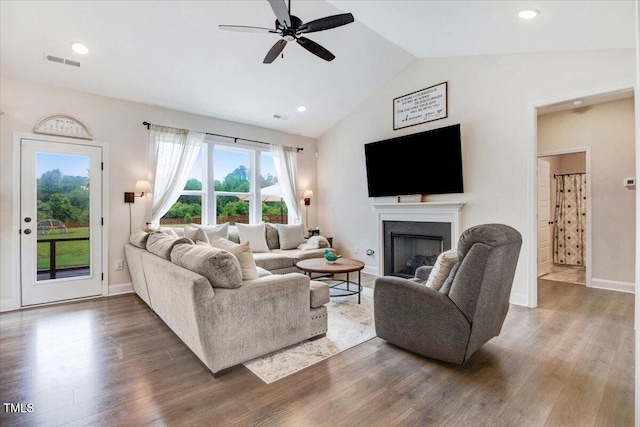 282 Brodie Rose Landing Way, Smithfield, NC 27577 - living room featuring ceiling fan, vaulted ceiling, wood finished floors, and a fireplace