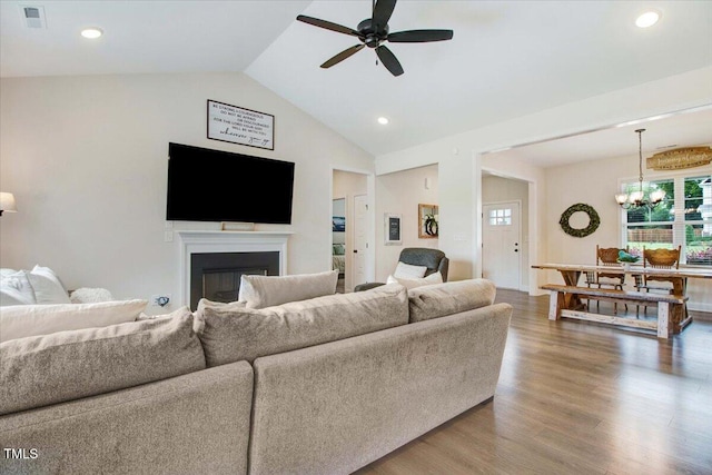 282 Brodie Rose Landing Way, Smithfield, NC 27577 - living room featuring a ceiling fan, vaulted ceiling, a fireplace, a chandelier, and wood finished floors