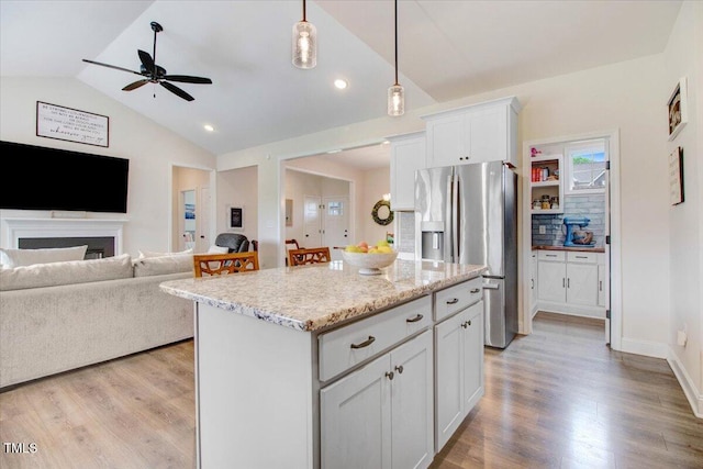 282 Brodie Rose Landing Way, Smithfield, NC 27577 - kitchen featuring stainless steel fridge, lofted ceiling, open floor plan, ceiling fan, and a center island