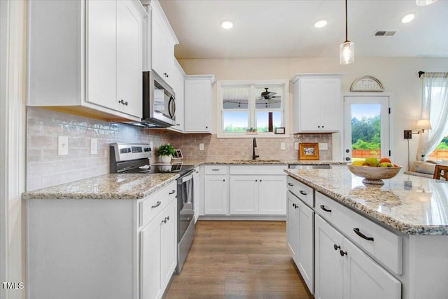 282 Brodie Rose Landing Way, Smithfield, NC 27577 - kitchen with appliances with stainless steel finishes, white cabinets, pendant lighting, tasteful backsplash, and recessed lighting
