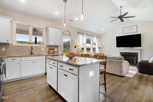 282 Brodie Rose Landing Way, Smithfield, NC 27577 - kitchen featuring lofted ceiling, a ceiling fan, a kitchen island, white cabinetry, and open floor plan
