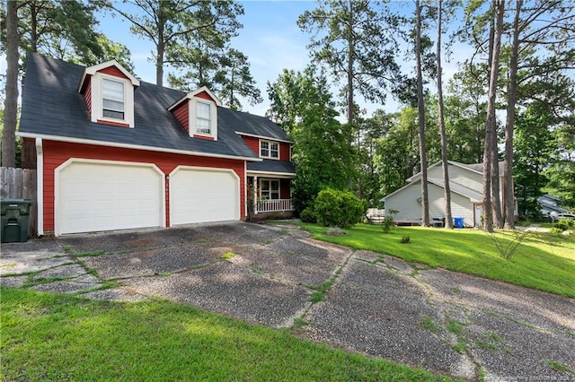 1612 Hennessy Pl, Fayetteville, NC 28303 - view of front of house with a front yard, driveway, a garage, and covered porch