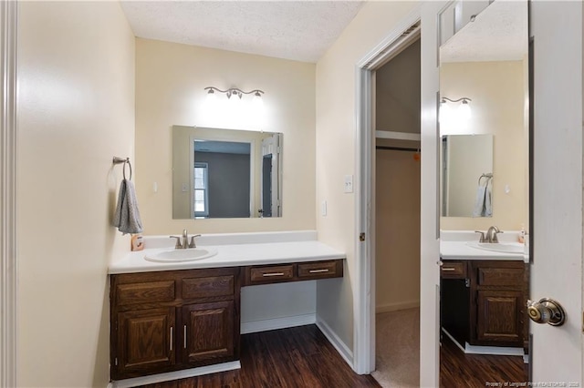 1612 Hennessy Pl, Fayetteville, NC 28303 - bathroom featuring vanity, a textured ceiling, and wood finished floors