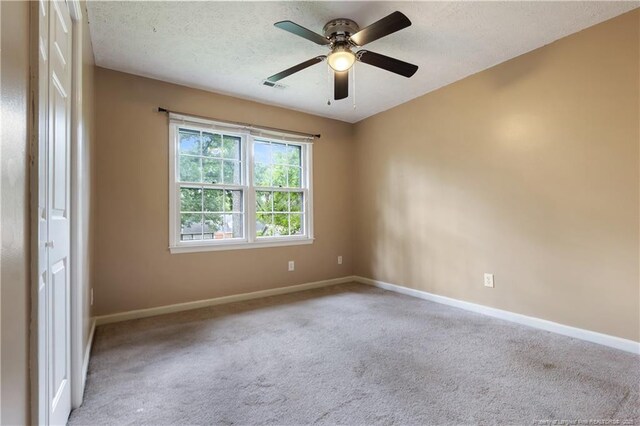 1612 Hennessy Pl, Fayetteville, NC 28303 - spare room with carpet, a ceiling fan, and a textured ceiling