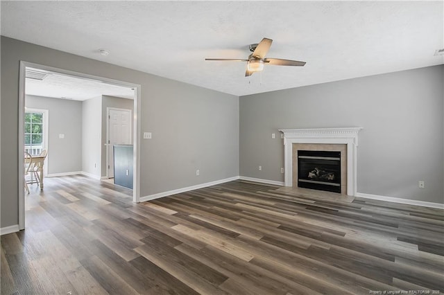 69 Ribbon Oak Ct, Sanford, NC 27332 - unfurnished living room with ceiling fan, dark wood-style floors, and a fireplace with flush hearth