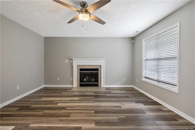 69 Ribbon Oak Ct, Sanford, NC 27332 - unfurnished living room with a ceiling fan, wood finished floors, a fireplace with flush hearth, and a textured ceiling