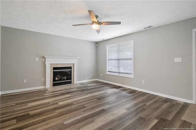 69 Ribbon Oak Ct, Sanford, NC 27332 - unfurnished living room with ceiling fan, a textured ceiling, wood finished floors, and a fireplace