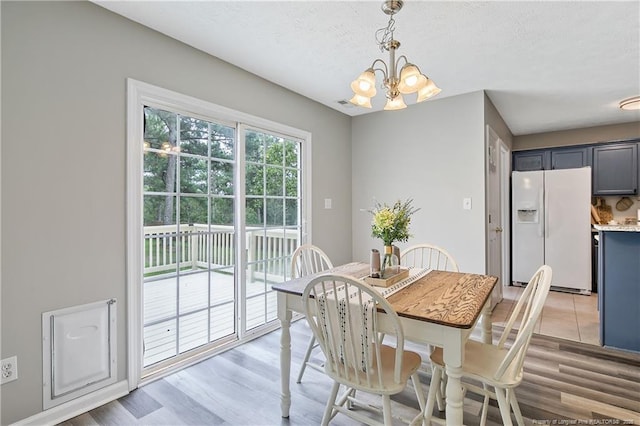 69 Ribbon Oak Ct, Sanford, NC 27332 - dining area featuring a chandelier, light wood-style flooring, and a textured ceiling