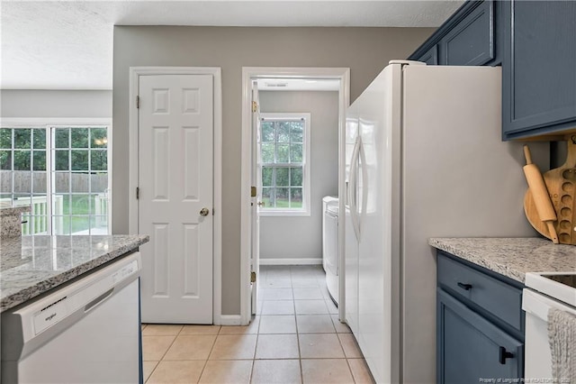 69 Ribbon Oak Ct, Sanford, NC 27332 - kitchen with white appliances, light tile patterned floors, light stone countertops, and separate washer and dryer
