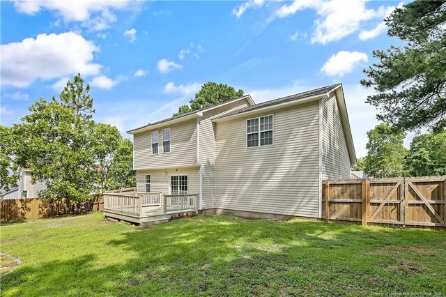 69 Ribbon Oak Ct, Sanford, NC 27332 - back of property with a deck, a fenced backyard, and a gate