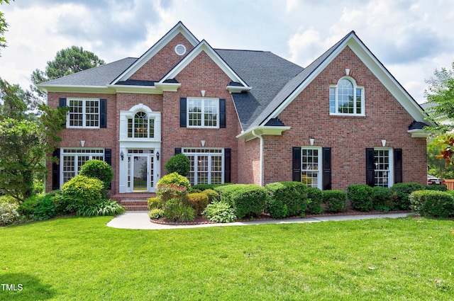500 Walcott Way, Cary, NC 27519 - colonial inspired home featuring a front yard, brick siding, and a shingled roof