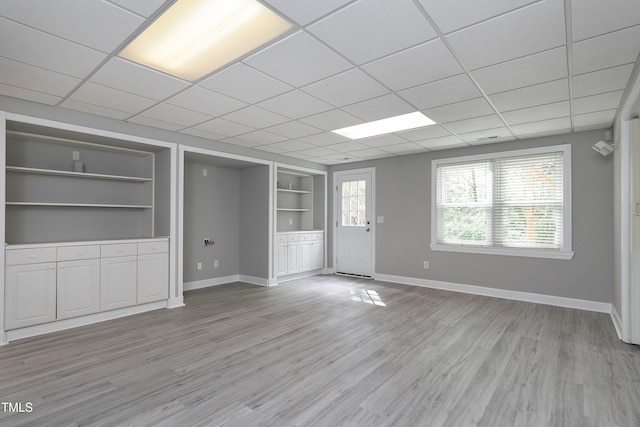 500 Walcott Way, Cary, NC 27519 - unfurnished living room featuring built in shelves, light wood finished floors, and a drop ceiling