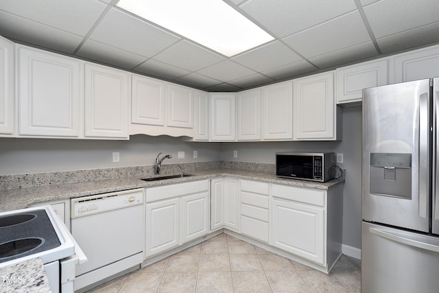 500 Walcott Way, Cary, NC 27519 - kitchen with appliances with stainless steel finishes, white cabinets, a paneled ceiling, light tile patterned floors, and light stone counters