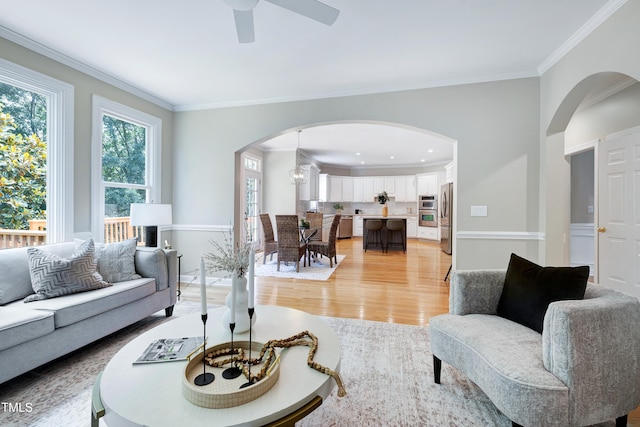 500 Walcott Way, Cary, NC 27519 - living room featuring arched walkways, ornamental molding, light wood-style floors, ceiling fan, and recessed lighting