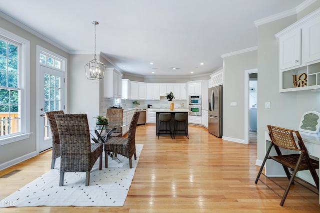 500 Walcott Way, Cary, NC 27519 - dining space featuring a chandelier, crown molding, light wood-style floors, and recessed lighting