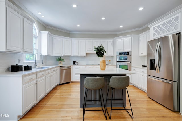 500 Walcott Way, Cary, NC 27519 - kitchen with stainless steel appliances, a center island, white cabinetry, crown molding, and recessed lighting