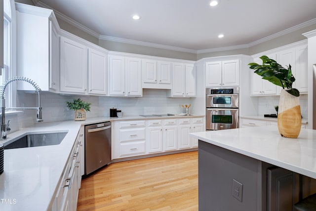 500 Walcott Way, Cary, NC 27519 - kitchen with appliances with stainless steel finishes, decorative backsplash, white cabinetry, recessed lighting, and light wood-type flooring