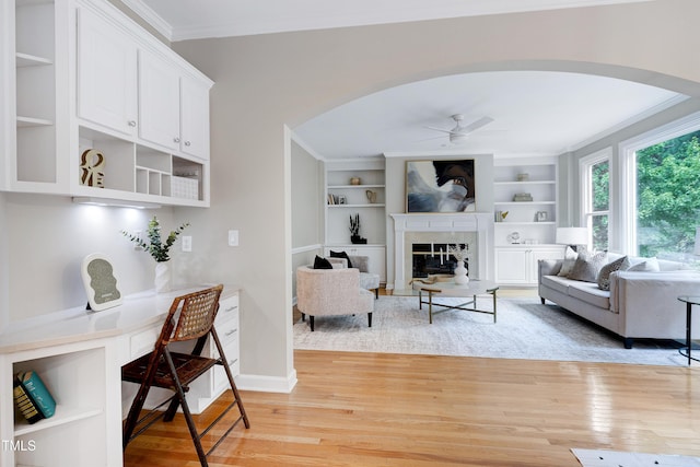 500 Walcott Way, Cary, NC 27519 - living room with arched walkways, light wood-type flooring, crown molding, and a ceiling fan