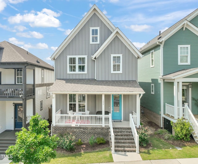 1006 Whistler St, Durham, NC 27713 - view of front of house featuring board and batten siding, covered porch, and a shingled roof
