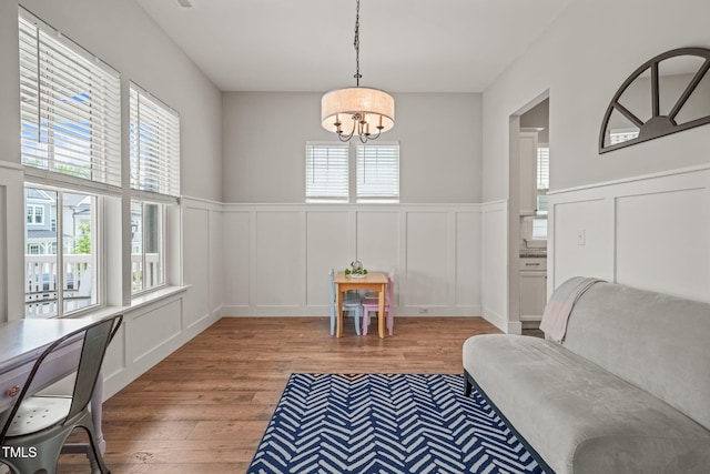1006 Whistler St, Durham, NC 27713 - living area with a decorative wall, wood finished floors, plenty of natural light, a chandelier, and wainscoting