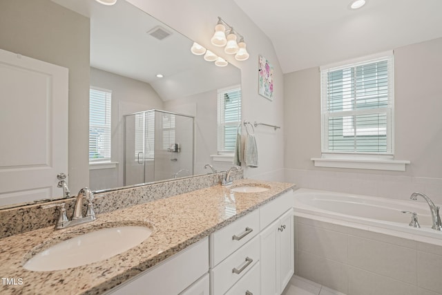 1006 Whistler St, Durham, NC 27713 - full bath with a shower stall, double vanity, a garden tub, vaulted ceiling, and recessed lighting