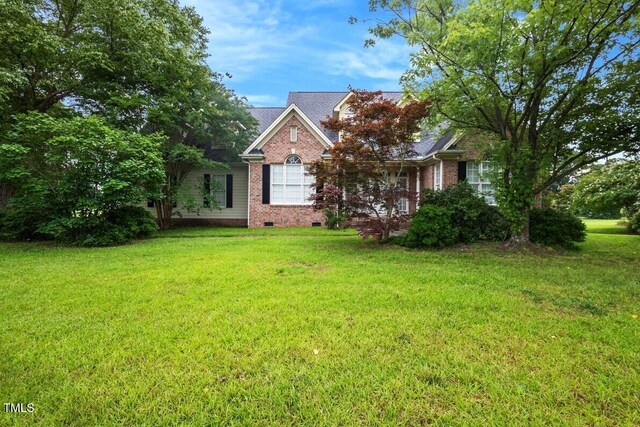 1016 Pasture View Ln, Raleigh, NC 27603 - view of front of home featuring brick siding, crawl space, and a front yard