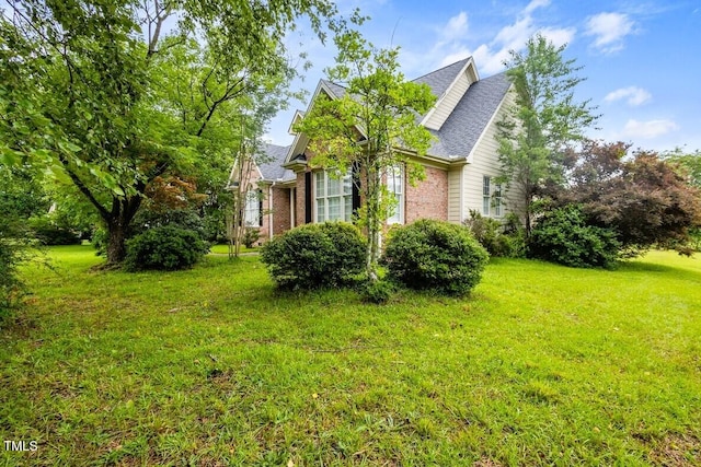 1016 Pasture View Ln, Raleigh, NC 27603 - view of property exterior featuring brick siding, a yard, and a shingled roof