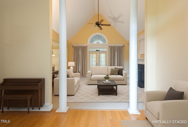1016 Pasture View Ln, Raleigh, NC 27603 - living area with decorative columns, wood finished floors, a fireplace, a ceiling fan, and high vaulted ceiling