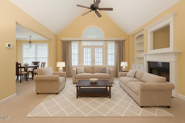 1016 Pasture View Ln, Raleigh, NC 27603 - living room featuring light colored carpet, ceiling fan, a fireplace, built in features, and high vaulted ceiling