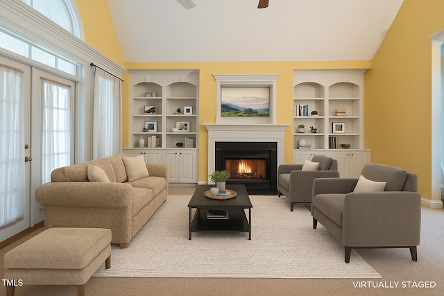 1016 Pasture View Ln, Raleigh, NC 27603 - living area featuring a fireplace with flush hearth, built in shelves, ceiling fan, and high vaulted ceiling