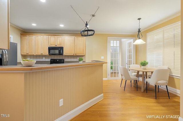 1016 Pasture View Ln, Raleigh, NC 27603 - kitchen featuring black microwave, range, stainless steel fridge, light brown cabinets, and backsplash
