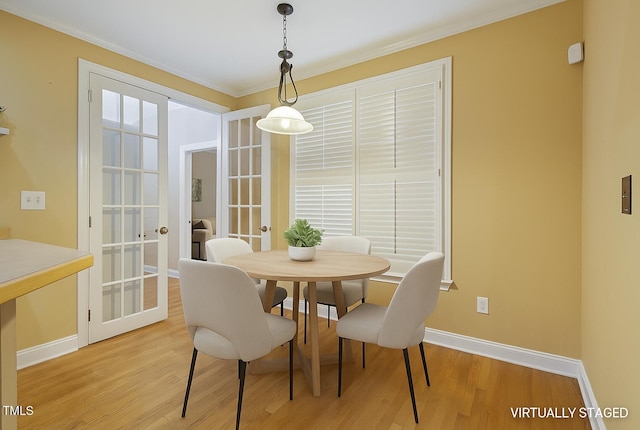 1016 Pasture View Ln, Raleigh, NC 27603 - dining space featuring french doors, light wood-style floors, and crown molding
