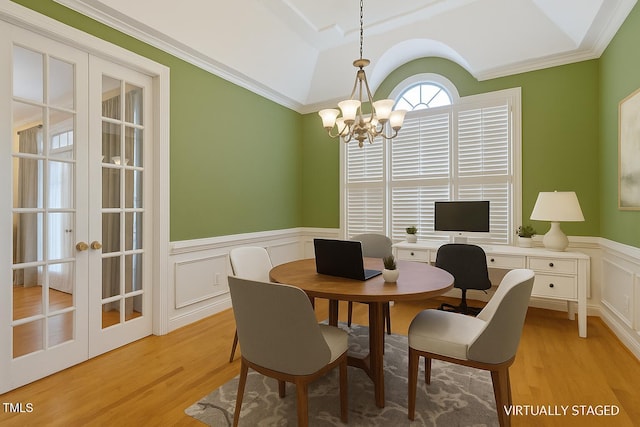 1016 Pasture View Ln, Raleigh, NC 27603 - dining space with french doors, light wood finished floors, a chandelier, wainscoting, and vaulted ceiling