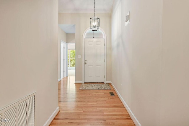 125 Chimney Rise Dr, Cary, NC 27511 - entryway with light wood finished floors and a chandelier