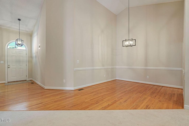 125 Chimney Rise Dr, Cary, NC 27511 - entrance foyer with a chandelier, lofted ceiling, and wood finished floors