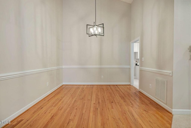 125 Chimney Rise Dr, Cary, NC 27511 - unfurnished dining area featuring wood finished floors and a chandelier