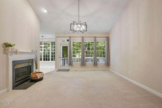 125 Chimney Rise Dr, Cary, NC 27511 - unfurnished living room with a chandelier, carpet flooring, and a fireplace with flush hearth