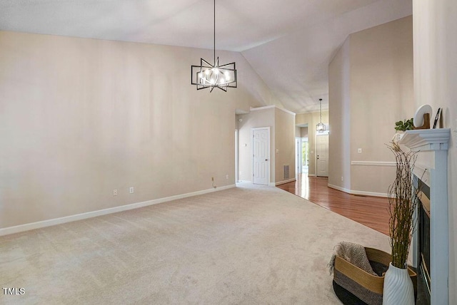 125 Chimney Rise Dr, Cary, NC 27511 - entryway with a chandelier, lofted ceiling, carpet flooring, and a fireplace