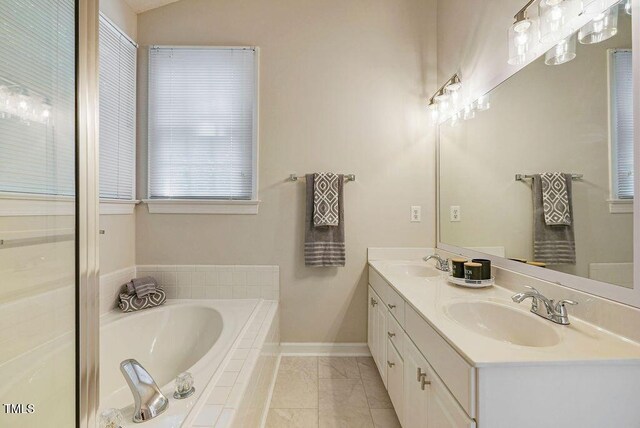 125 Chimney Rise Dr, Cary, NC 27511 - bathroom featuring double vanity, a bath, and marble look tile flooring