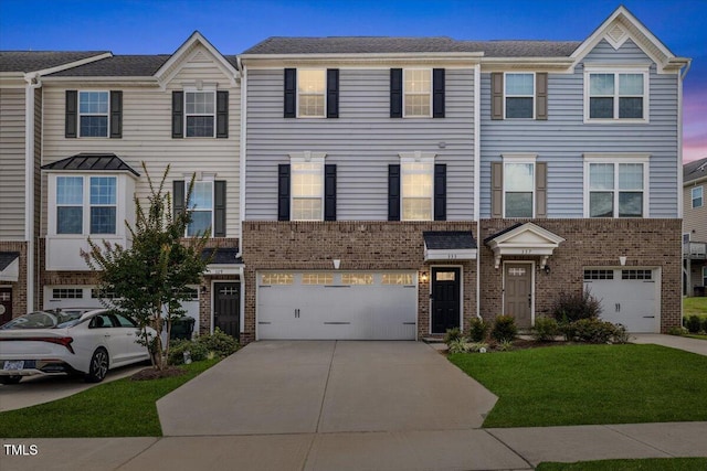 333 Amber Acorn Ave, Raleigh, NC 27603 - view of property featuring an attached garage, concrete driveway, and brick siding
