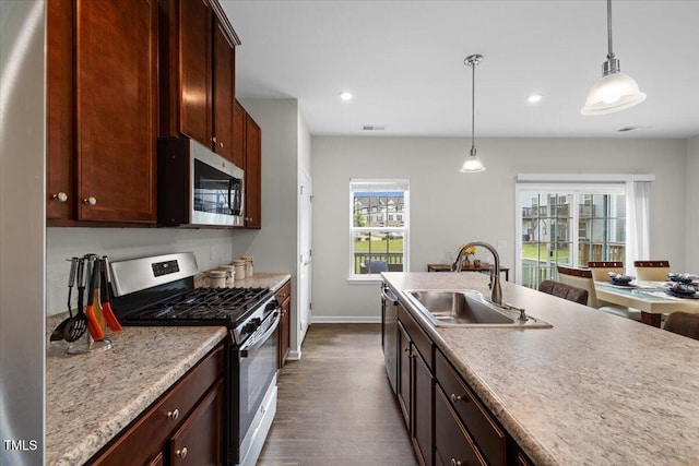 333 Amber Acorn Ave, Raleigh, NC 27603 - kitchen with appliances with stainless steel finishes, dark wood-type flooring, hanging light fixtures, recessed lighting, and light countertops