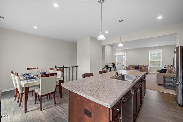 333 Amber Acorn Ave, Raleigh, NC 27603 - kitchen with appliances with stainless steel finishes, open floor plan, dark wood-style floors, recessed lighting, and light countertops