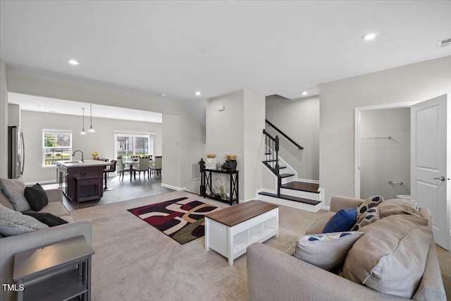 333 Amber Acorn Ave, Raleigh, NC 27603 - living room featuring recessed lighting, stairs, and light colored carpet