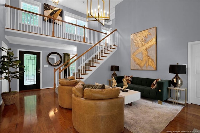 4010 Arcadia Ct, Fayetteville, NC 28311 - living room featuring a high ceiling, stairway, wood finished floors, and a chandelier