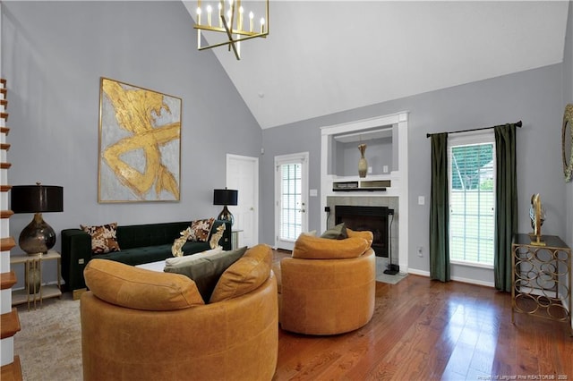 4010 Arcadia Ct, Fayetteville, NC 28311 - living room with high vaulted ceiling, healthy amount of natural light, wood finished floors, a chandelier, and a fireplace