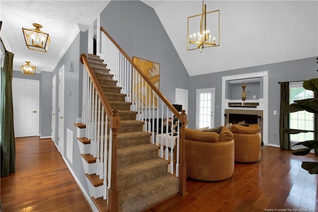 4010 Arcadia Ct, Fayetteville, NC 28311 - stairway with a chandelier, wood finished floors, plenty of natural light, and high vaulted ceiling
