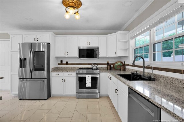 4010 Arcadia Ct, Fayetteville, NC 28311 - kitchen with stainless steel appliances, light marble finish floors, ornamental molding, light stone countertops, and white cabinets
